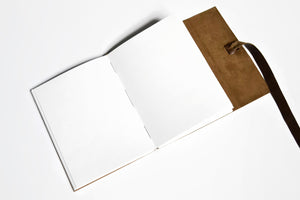Interior view of unlined pages in an unlined leather journal