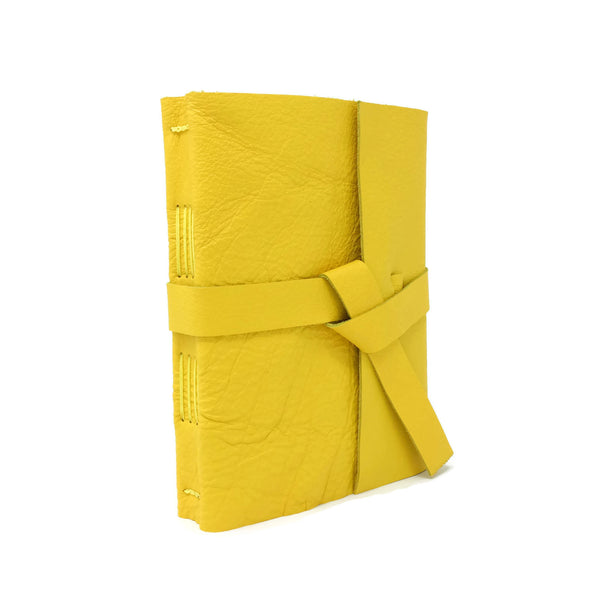 Angled front view of yellow leather journal notebook