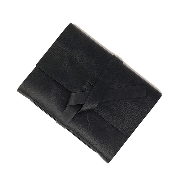 Top angle of black leather slim notebook