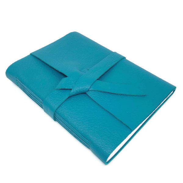 Top angle view of teal blue leather travel journal